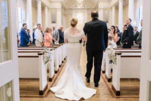 A couple walking down an aisle to get married
