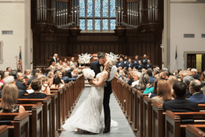 A married couple kissing in a church